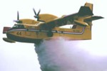 Canadair plane dropping water